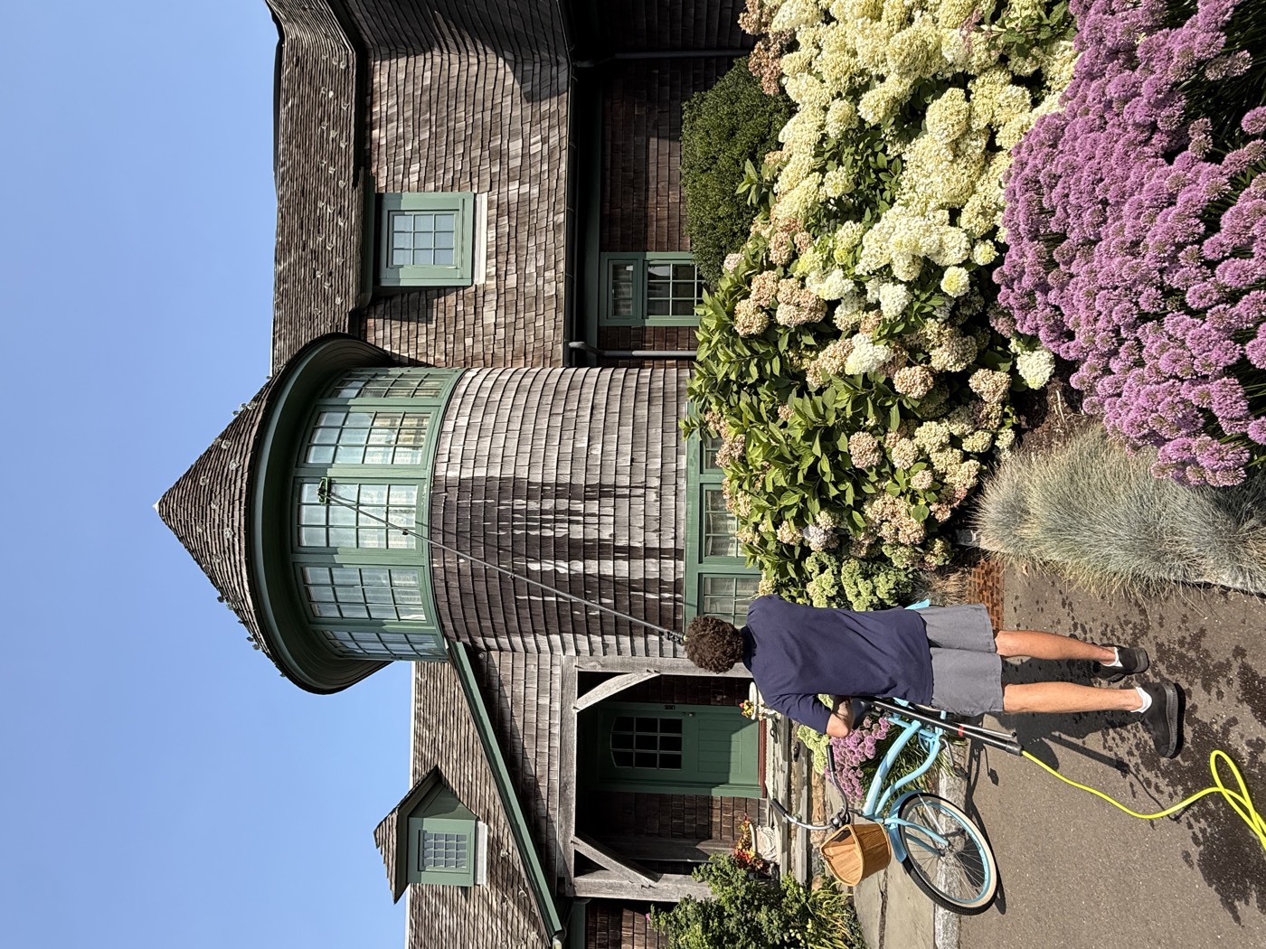 Clear View technician pole-cleaning the turret windows of a cedar-shingle Connecticut estate