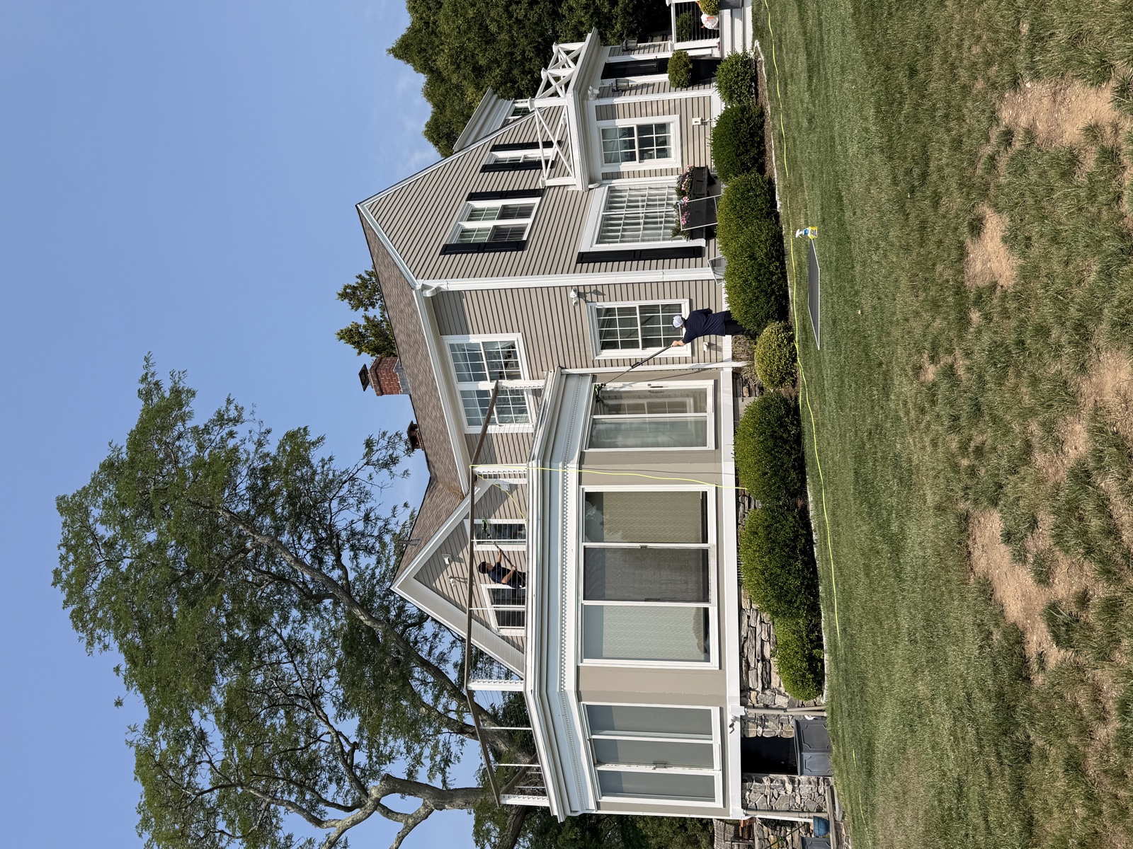 Clear View technician cleaning a colonial's sunroom windows, Connecticut