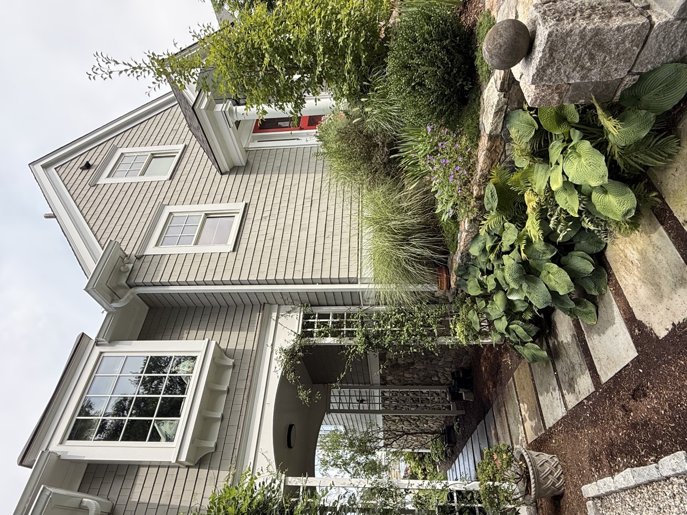 Front entry and stone walkway of a Connecticut shingle home with freshly cleaned windows by Clear View