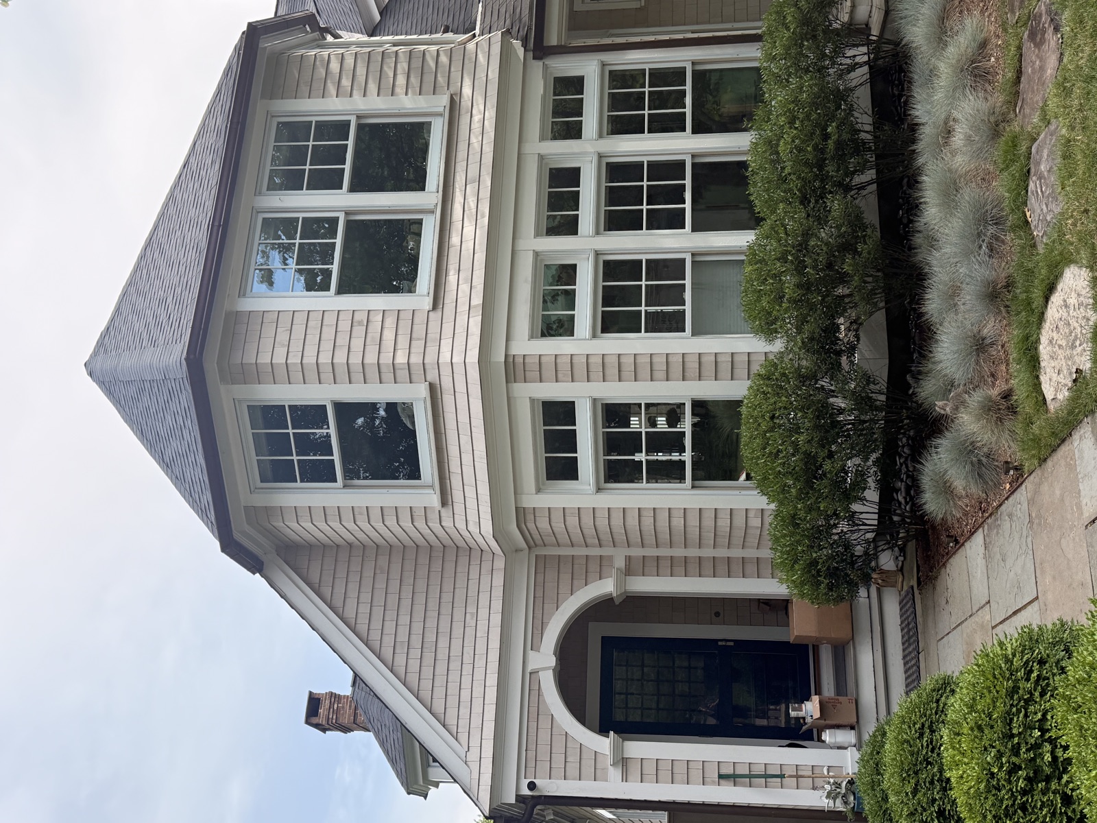 Pink cedar-shingle Connecticut home with spotless bay windows, Clear View