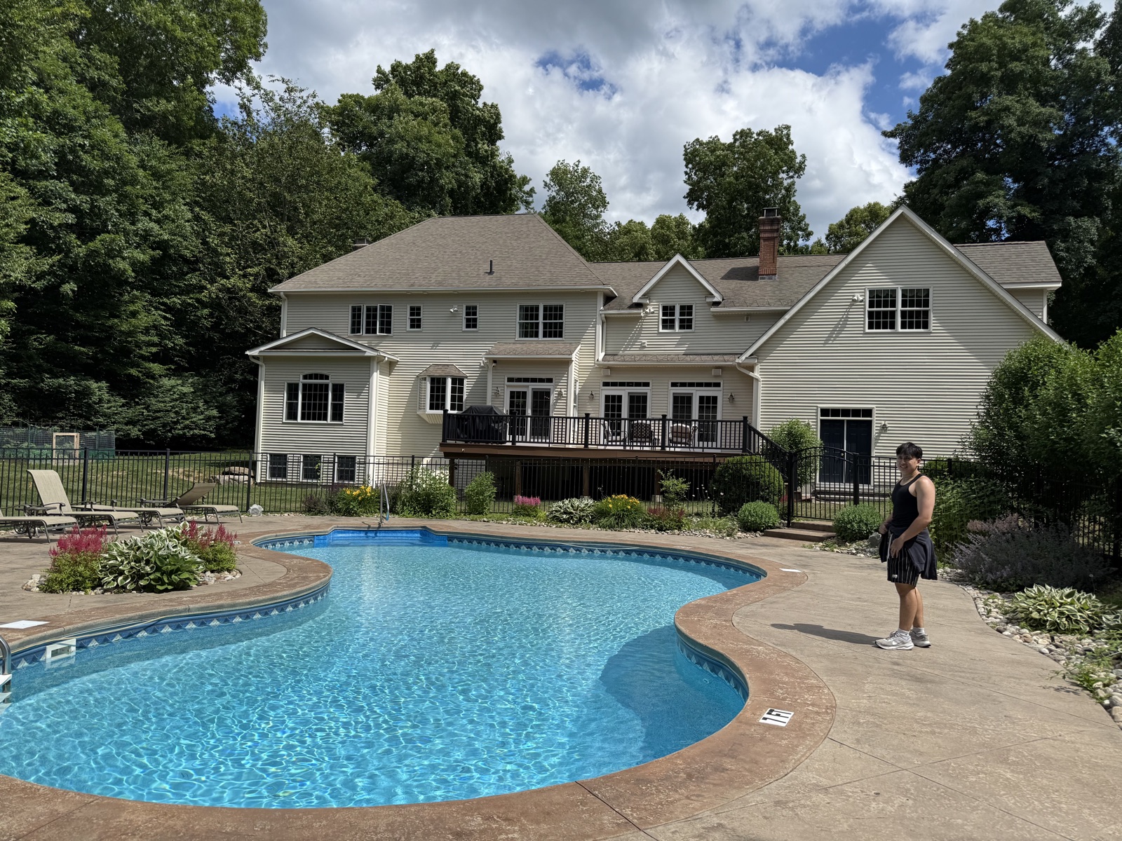 Poolside view of a Connecticut colonial with freshly cleaned windows, Clear View