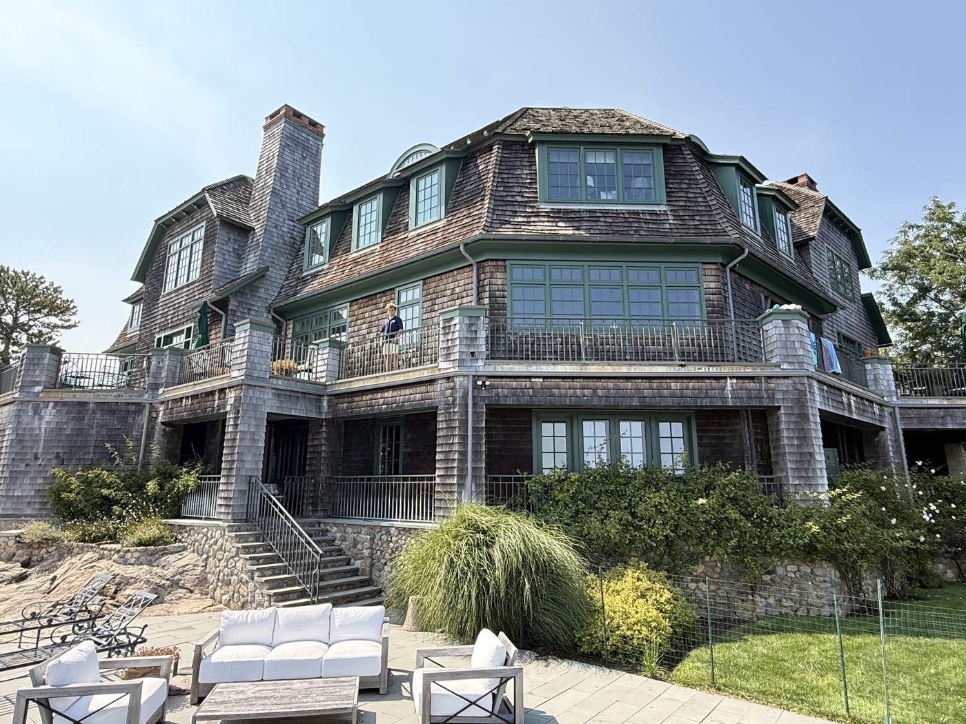 Cedar-shingle Connecticut estate above a stone terrace, all windows cleaned by Clear View