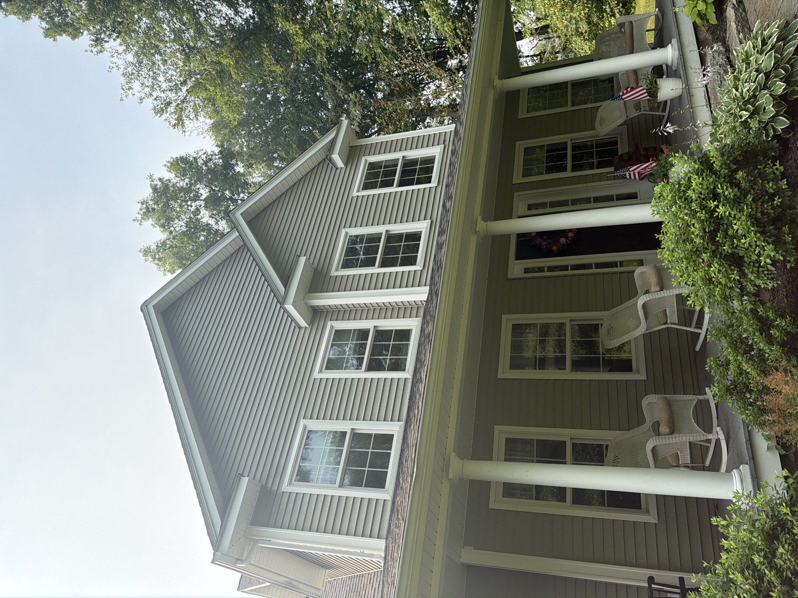 Two-person Clear View crew pure-water pole cleaning a shingle home's bay windows, CT