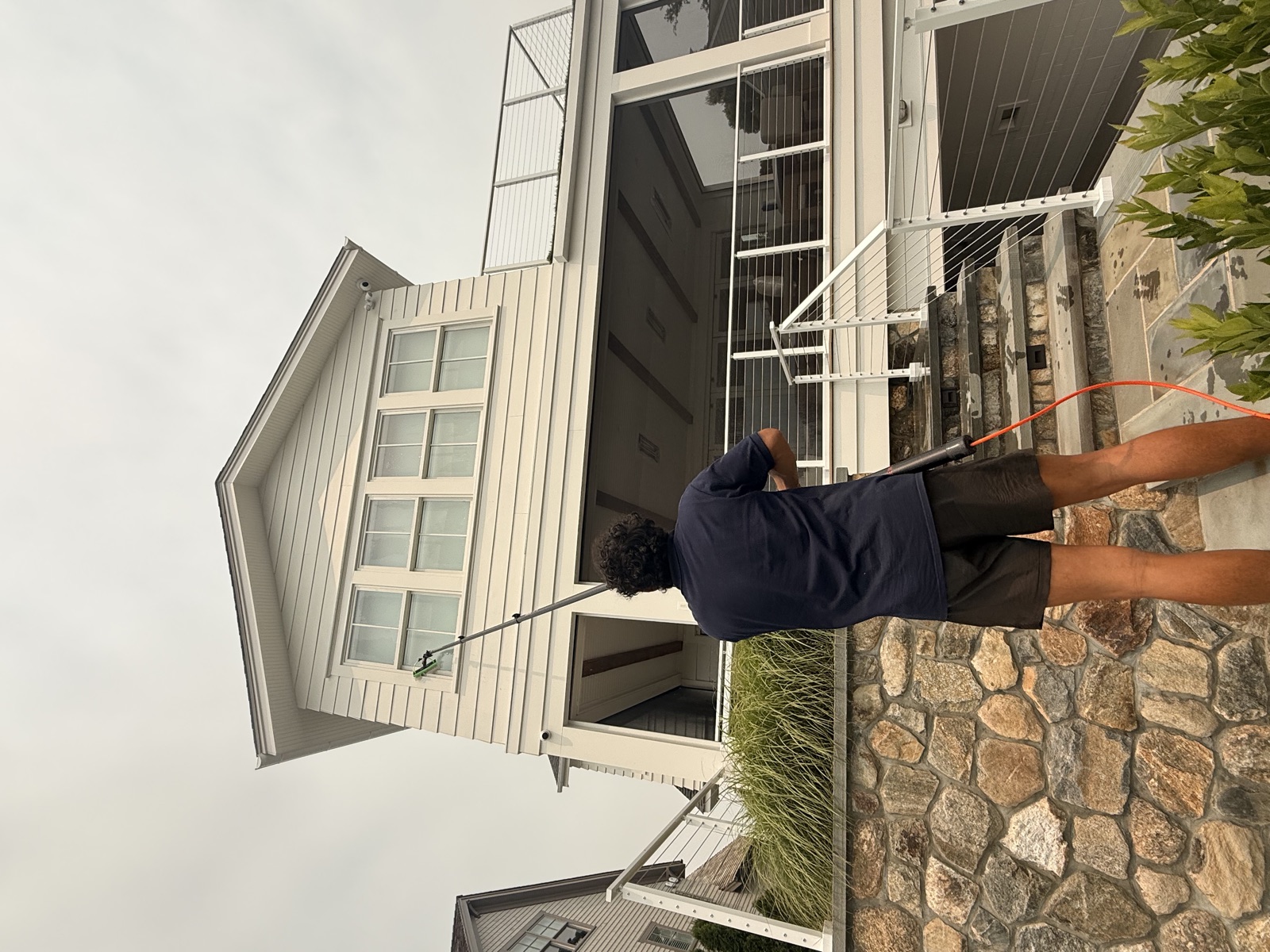 Water-fed pole cleaning of a modern shoreline home with harbor views, Connecticut