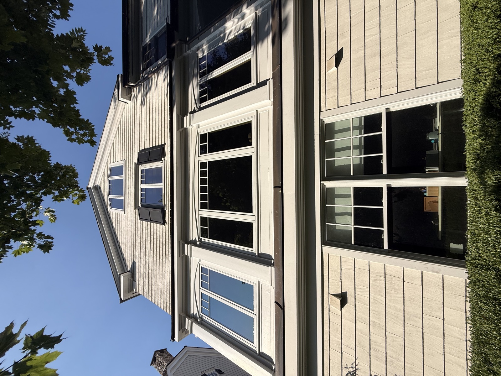 Upward view of a shingle-style Connecticut home with spotless windows, Clear View
