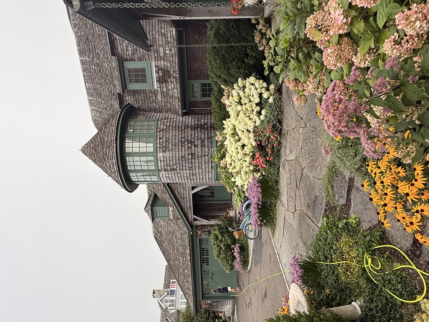 Turret and flower beds at a cedar-shingle Connecticut estate serviced by Clear View Window Co.