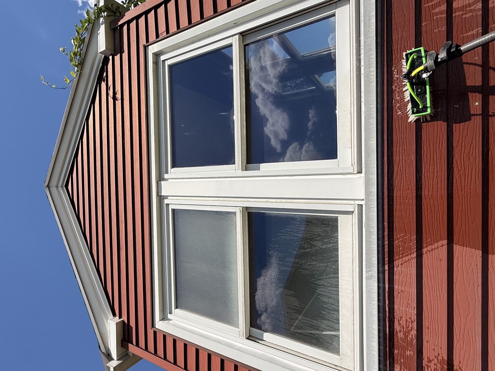Window mid-clean — hard-water haze on the left, clear glass on the right, by Clear View, Connecticut