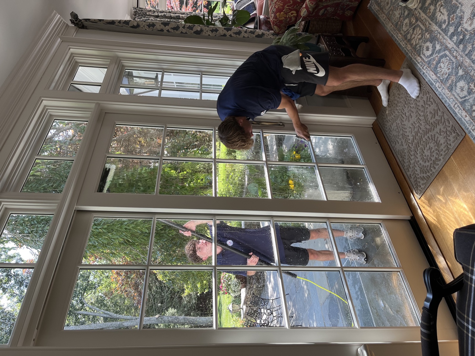 Two Clear View technicians cleaning French doors inside and out, Connecticut